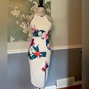 Mid length white floral dress with cut outs on the side. Size medium!